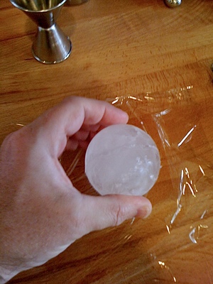 Round Spherical Ice Cube Ball In A Cocktail Glass With Unique Rim